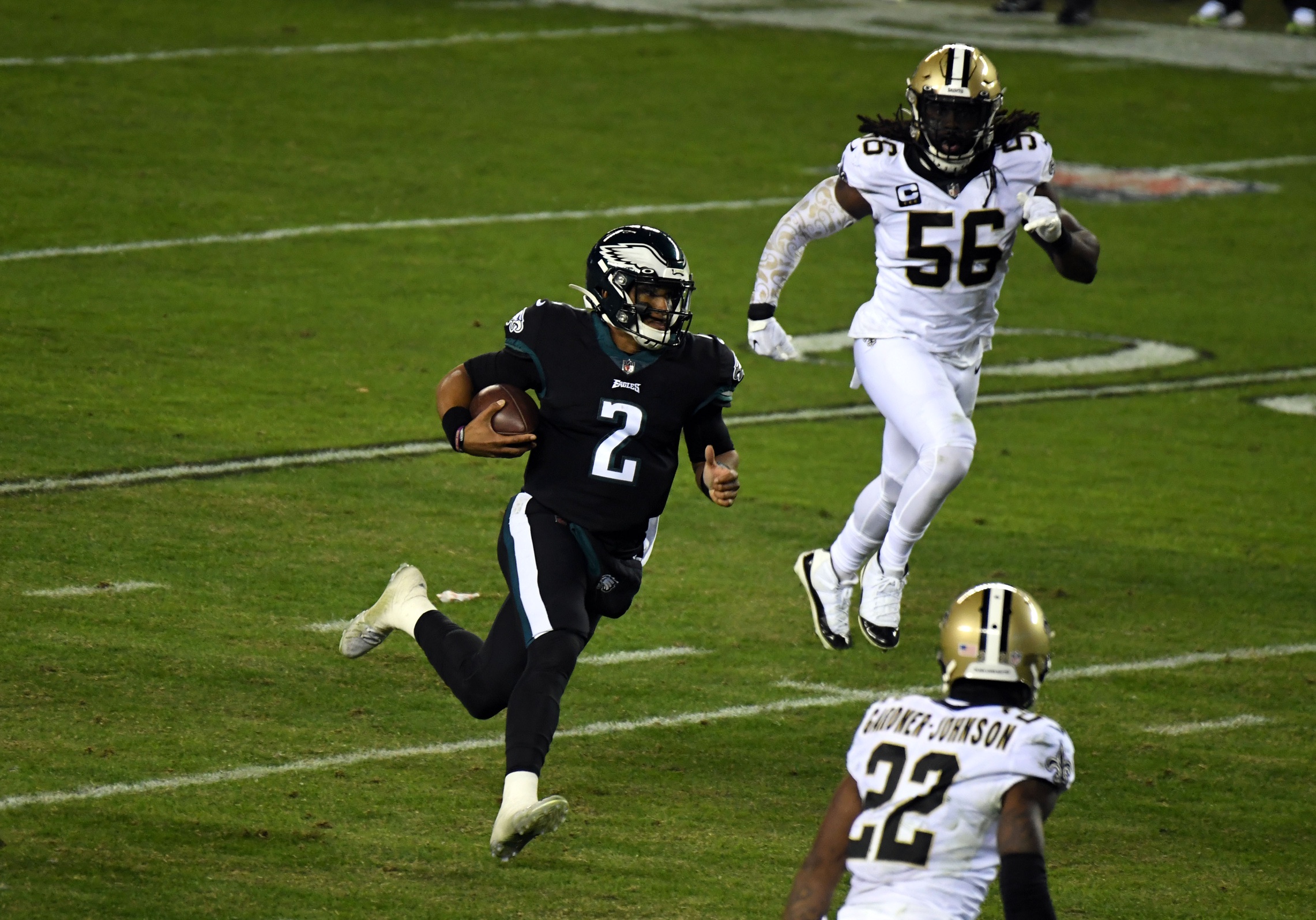 Eagles quarterback Jalen Hurts (2) rushes the ball as New Orleans Saints linebacker Demario Davis (56) and safety Chauncey Gardner-Johnson (22) pursue. Mandatory Credit: James Lang-USA TODAY Sports